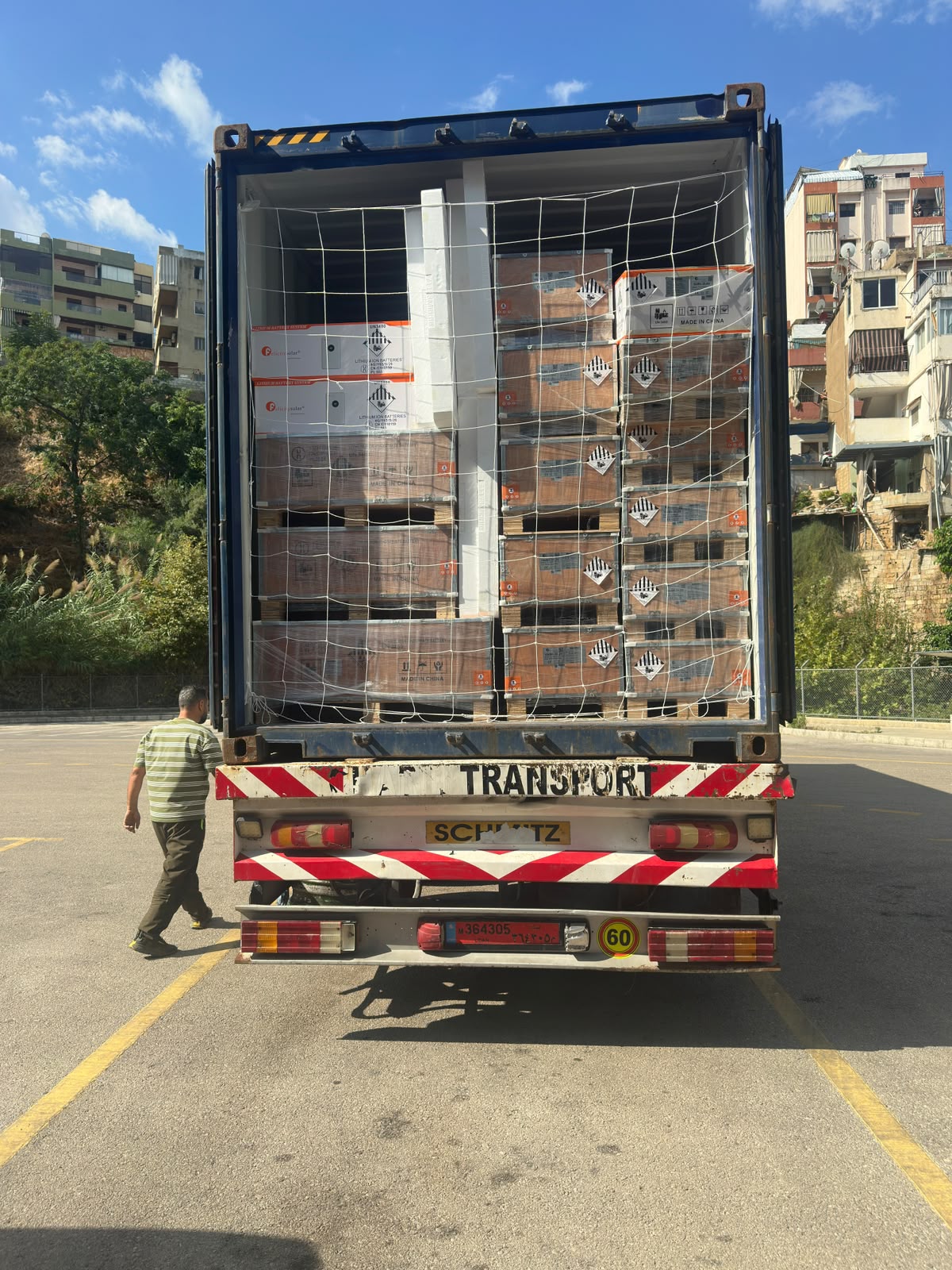 Container being loaded with palletised battery and inverter stock